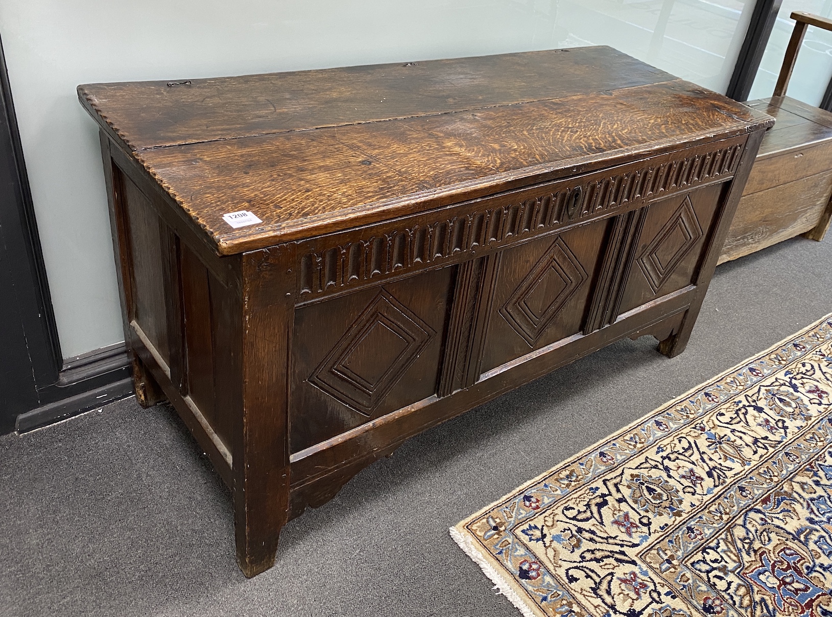 A late 17th century oak coffer, with a triple lozenge carved panelled front, width 133cm, depth 54cm, height 66cm